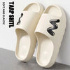 A pair of beige EVA slide slippers featuring a black wavy design on the top, shown against a white background.