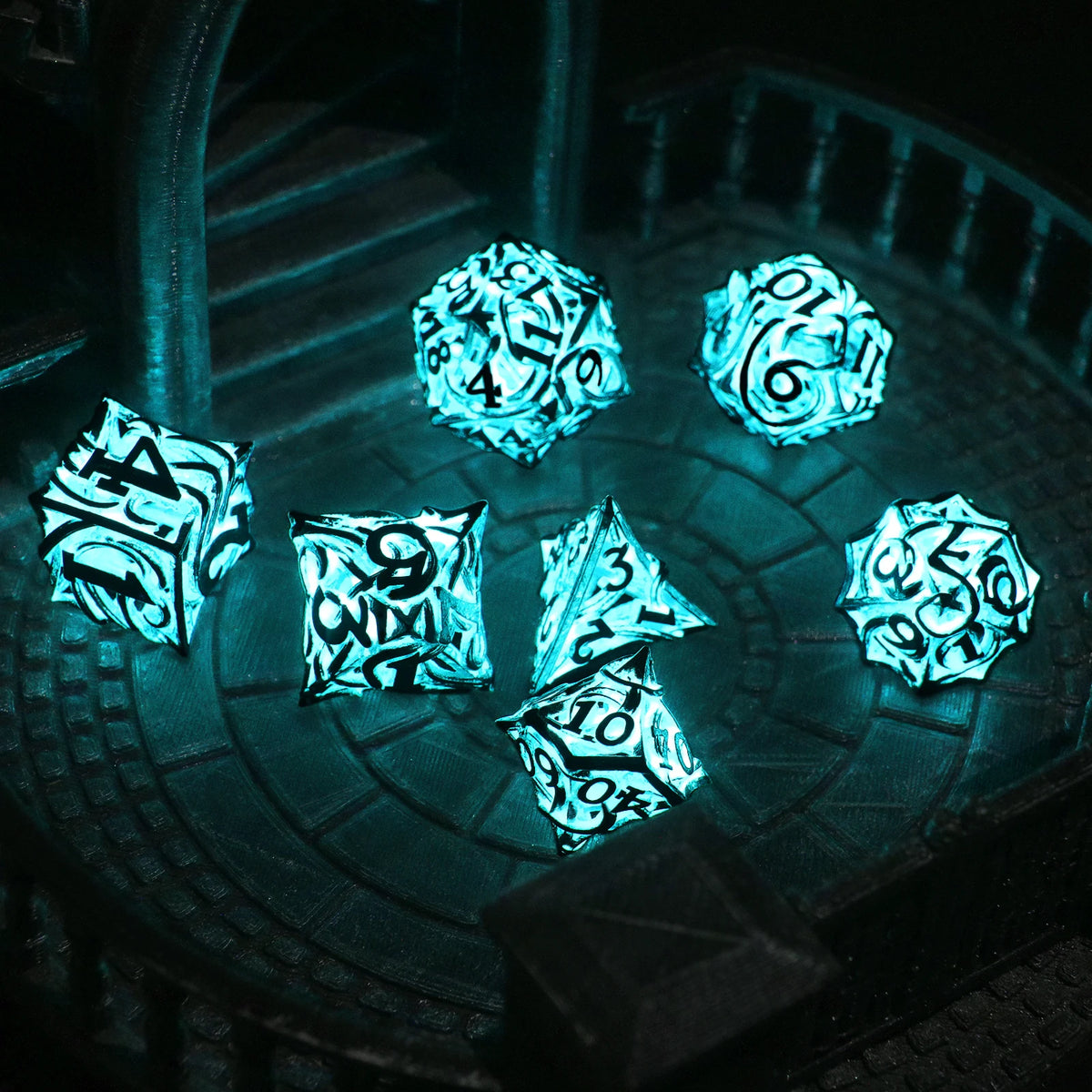 A set of polyhedral dice with a glow-in-the-dark effect resting on a dark, textured surface.