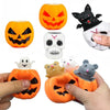A collection of Halloween squeeze stress balls featuring pumpkin and skull designs in orange, black, and white.