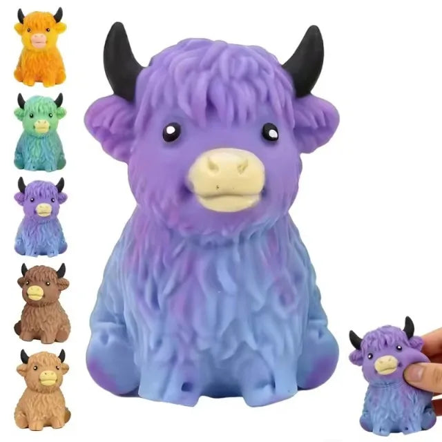 A purple glitter highland cow squishy stress relief toy with black horns and a yellow nose.