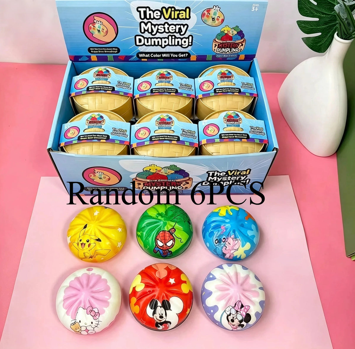A box of Viral Mystery Dumplings containing six colorful squishy fidget toys and a set of round cartoon pattern squishies