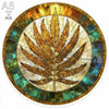 A circular wooden puzzle featuring a detailed leaf design with a golden and green color palette.