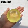 A hand holds a translucent yellow Vaseline fidget ball for stress relief.