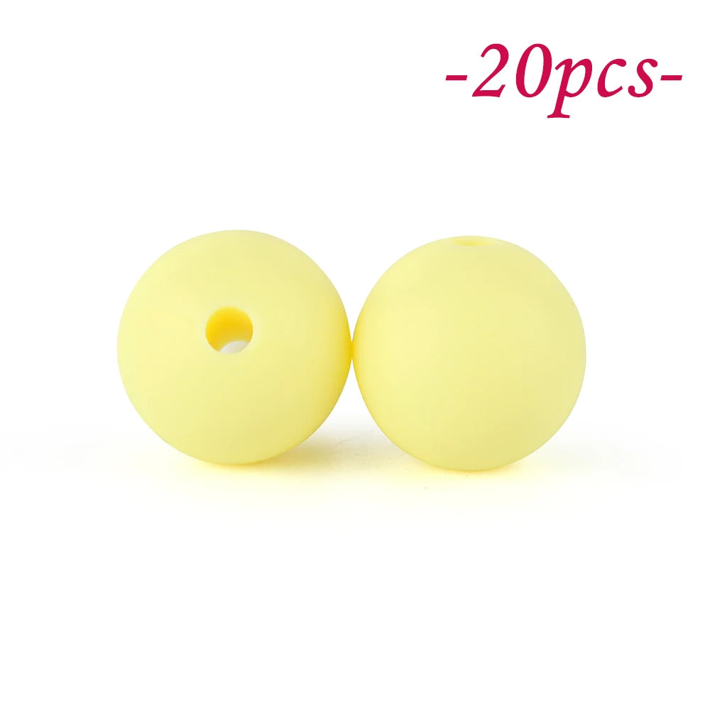 Two yellow silicone beads are shown against a white background, indicating a set of soft beads for jewelry making.