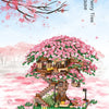 A detailed building block set of a cherry tree featuring pink blossoms and a small house structure.