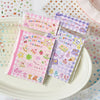 A set of 32 die-cut sticker sheets featuring cute cartoon characters and designs in pink and purple.