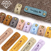 A collection of 20 leather-style handmade with love tags in various shades of brown, gray, and blue.