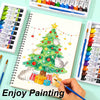 A set of 12-color acrylic, watercolor, and glass paints is displayed alongside a notebook featuring a Christmas tree drawing.