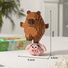 A small, detailed building block model of a brown capybara standing on a pink base.