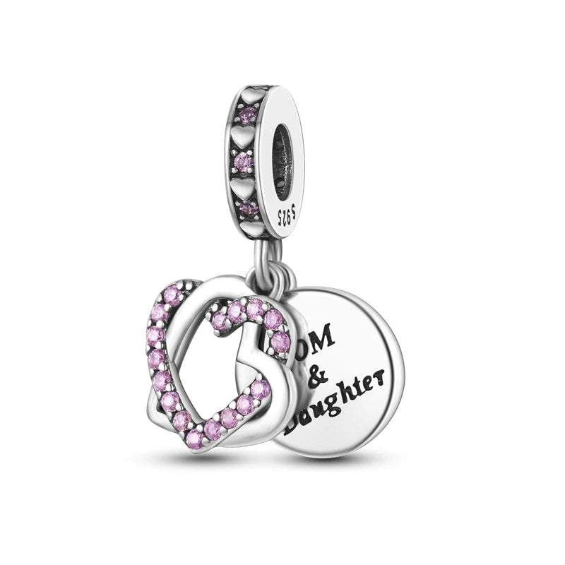 A silver heart charm bead featuring pink zircon stones, designed as a dangle or pendant.