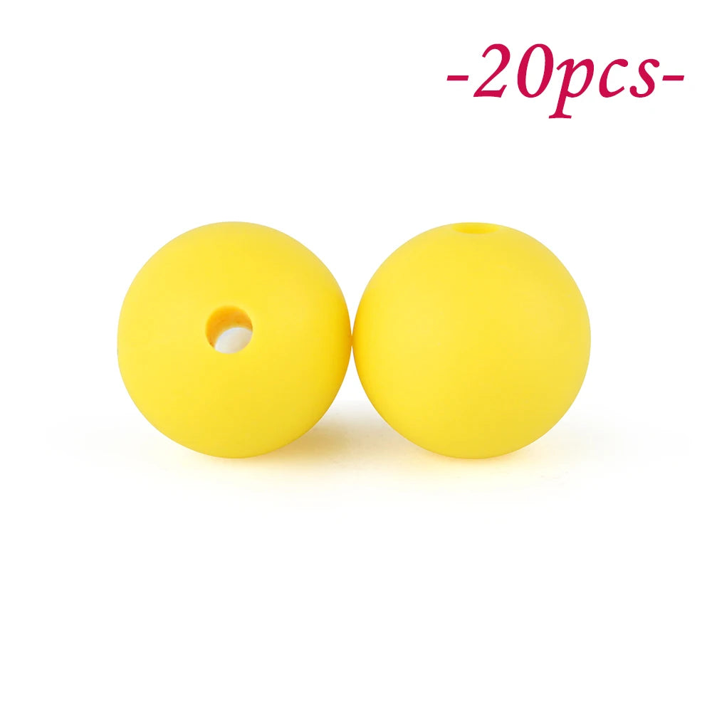 Two yellow silicone beads are shown against a white background.