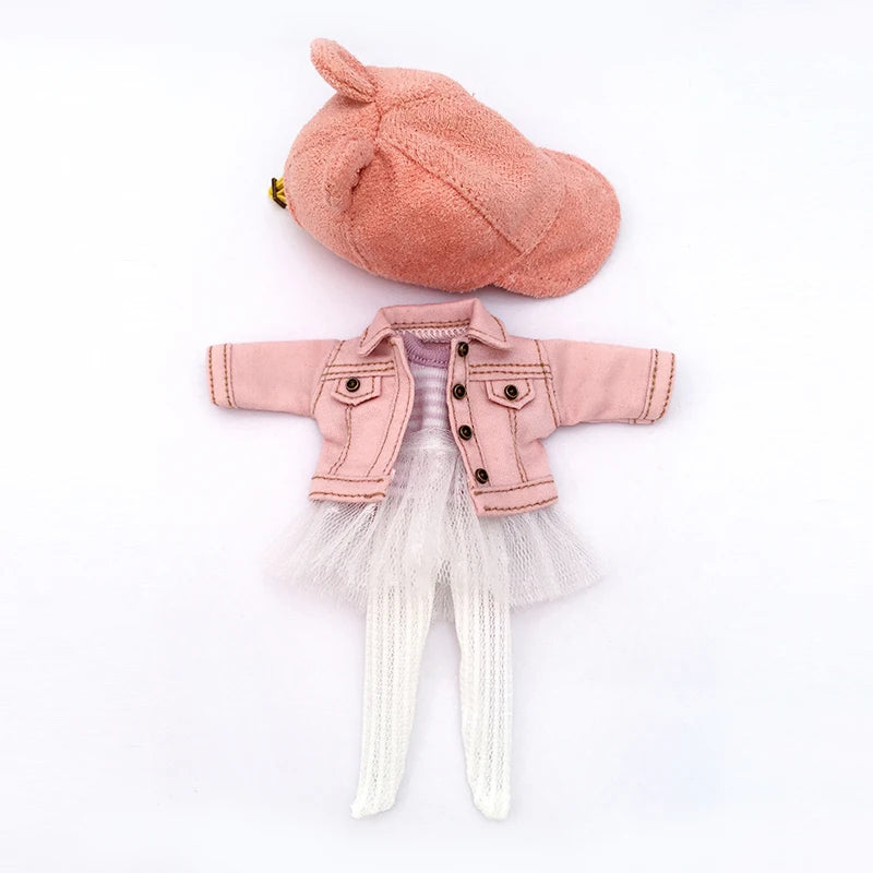 A pink denim jacket for a 1/12 scale doll displayed next to a matching pink fuzzy hat.