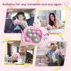 A pink Pop It fidget game console is shown being used by a child, mother, older person, and worker.