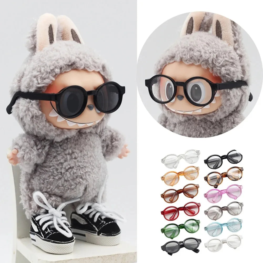 A fluffy gray rabbit doll wearing round black glasses and a knitted hat.