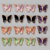 A collection of crystal butterfly charm beads in various shades of pink, purple, and green.