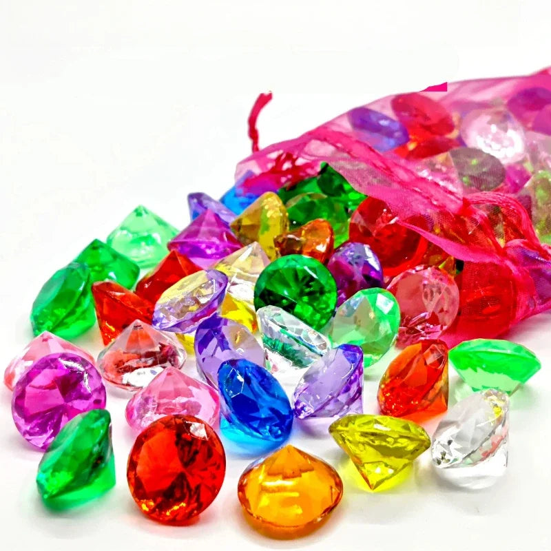 A collection of sparkling acrylic gemstones in various colors including red, green, purple, and yellow.