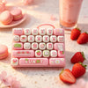 A pink and white cute keyboard keycap fidget stress relief charm with various numbers letters and a bunny keycap resting on a