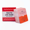 A box of Truth or Dare for Couples cards with a red and white design featuring prompts for date night fun.