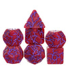 A set of seven frosted crack resin polyhedral dice in various colors and shapes.