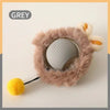 A grey motion-activated hide and seek cat toy with a rolling ball nestled in fluffy material.