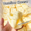 A hand holds a block of yellow Vaseline cheese cubes, showing the soft texture and squishy nature of the sensory toy.