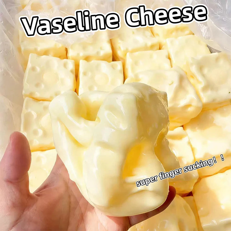 A hand holds a block of yellow Vaseline cheese cubes, showing the soft texture and squishy nature of the sensory toy.