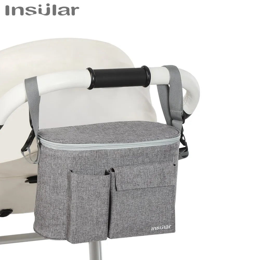 A gray Insular stroller organizer bag with a bottle holder is shown on a white baby stroller.