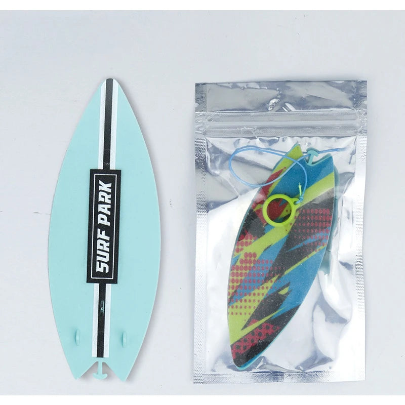 A teal finger skateboard is shown, with a packaged version of the board inside a clear plastic pouch.