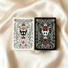 A black and white poker card deck featuring intricate line art designs on a square box.