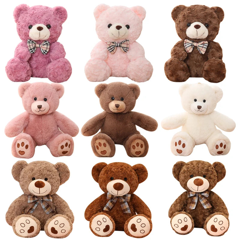 A collection of eight plush teddy bears in various colors including pink, beige, brown, and cream.