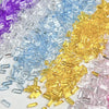 A pile of multicolor acrylic ice strips in purple, blue, yellow, and pink for nail art and DIY crafts.