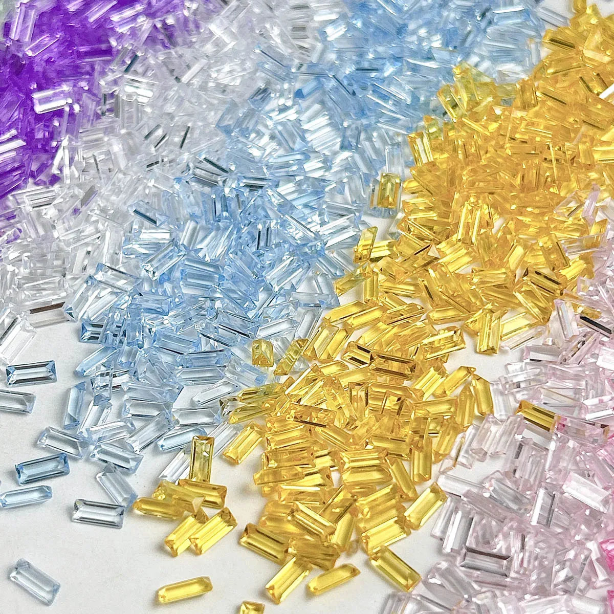 A pile of multicolor acrylic ice strips in purple, blue, yellow, and pink for nail art and DIY crafts.