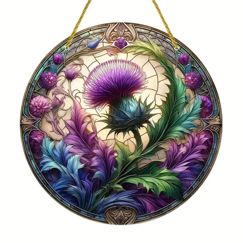 A round acrylic window hanging featuring a detailed floral design with purple and green thistle elements.