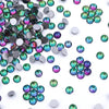 A collection of iridescent green and purple glass crystal flatback rhinestones for nail art and crafts.