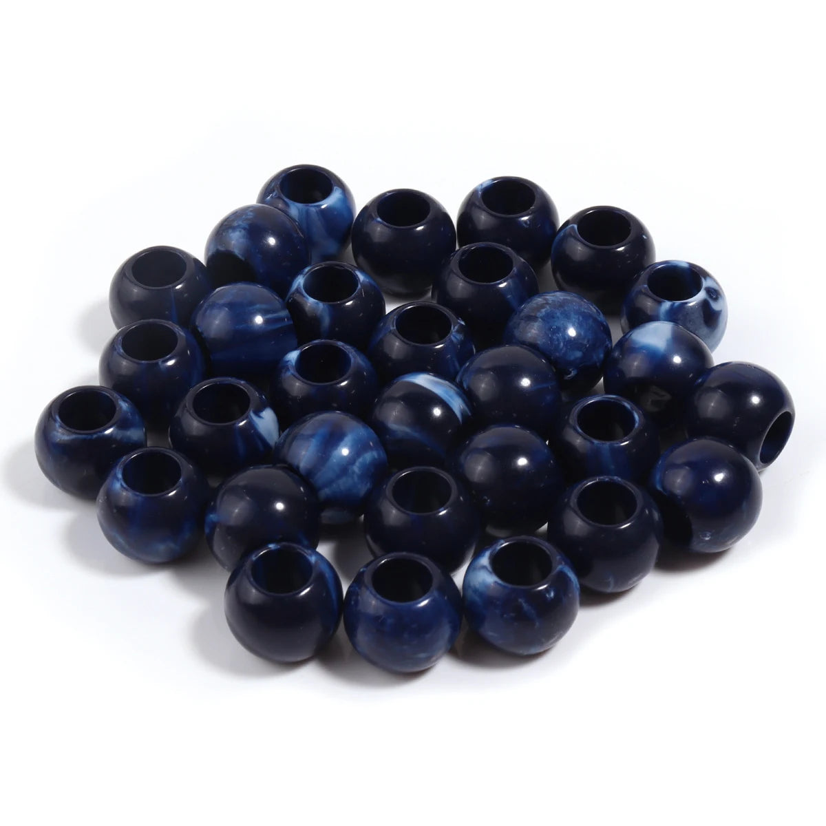 A pile of 50 imitation jade acrylic cloud beads in deep blue and purple shades for jewelry making