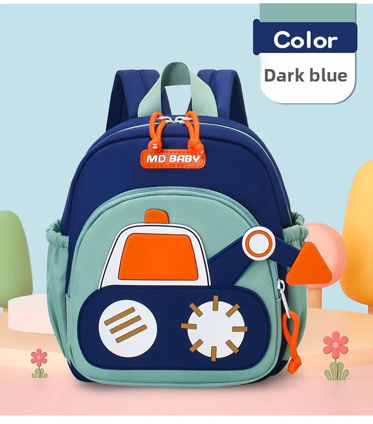 A dark blue kids cartoon digger truck backpack with orange accents and a green fabric on a light pink background.