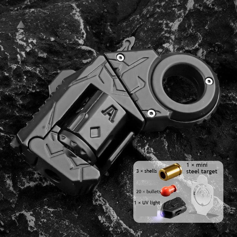 A black alloy fidget toy gun with a spinner and shell ejection mechanism shown on a dark surface.