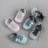 A collection of five breathable mesh toddler walking shoes in pink, gray, and mint green tones.