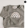 A gray long-sleeve top for a baby girl featuring a white rainbow graphic.