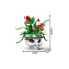 A set of gothic floral skull building blocks featuring vibrant green and pink flowers and leaves.