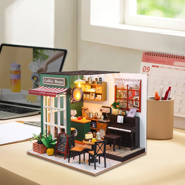 A handmade wooden miniature dollhouse kit depicting a cozy coffee house with a counter and interior details.