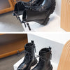 A pair of black girls' ankle boots with laces and anti-skid rubber soles displayed on a white surface.