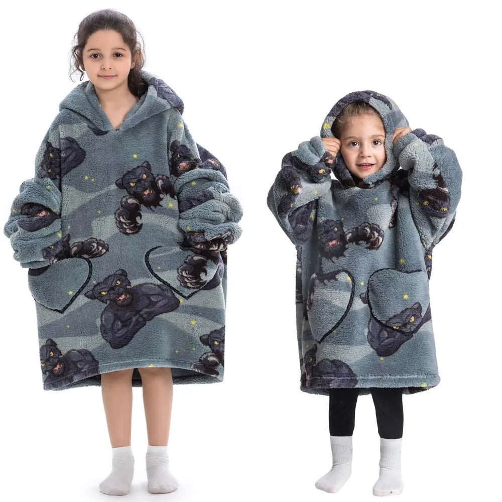 A girl models a gray and black fuzzy flannel hoodie sweater for kids.