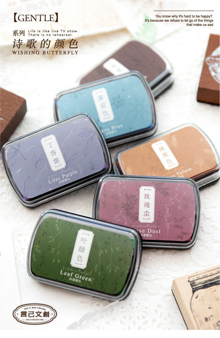 A collection of five vintage craft oil-based ink pads in various colors including Lilac Purple, Jade Blue, Yellow, and Leaf G