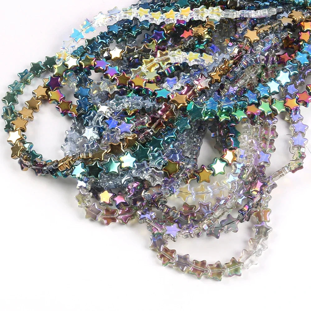 A tangled collection of iridescent, multi-colored glass star spacer beads for jewelry making.