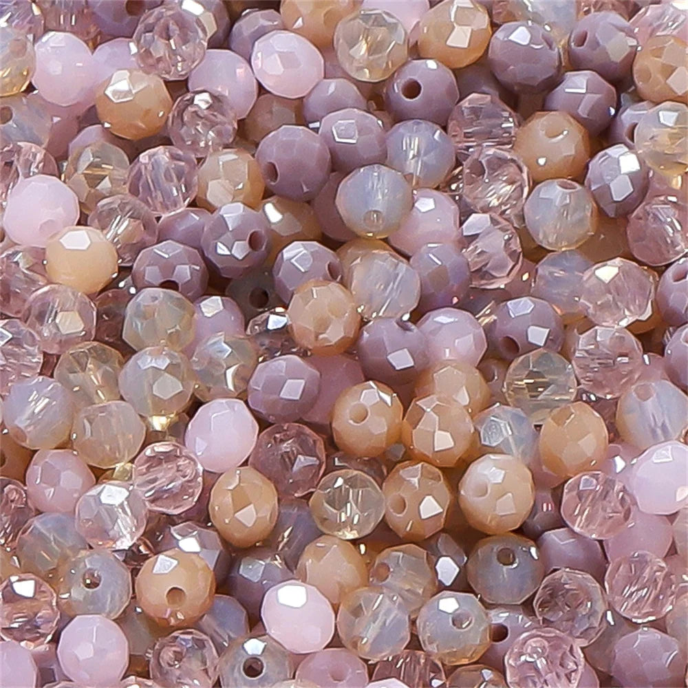 Mixed color faceted rondelle glass beads in shades of pink, beige, and purple for jewelry making