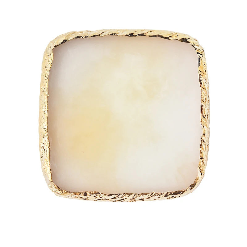 A square resin nail art palette with a white translucent base and a gold textured trim.