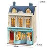 A detailed wooden dollhouse kit of a pink princess villa with architectural features and glass display windows.