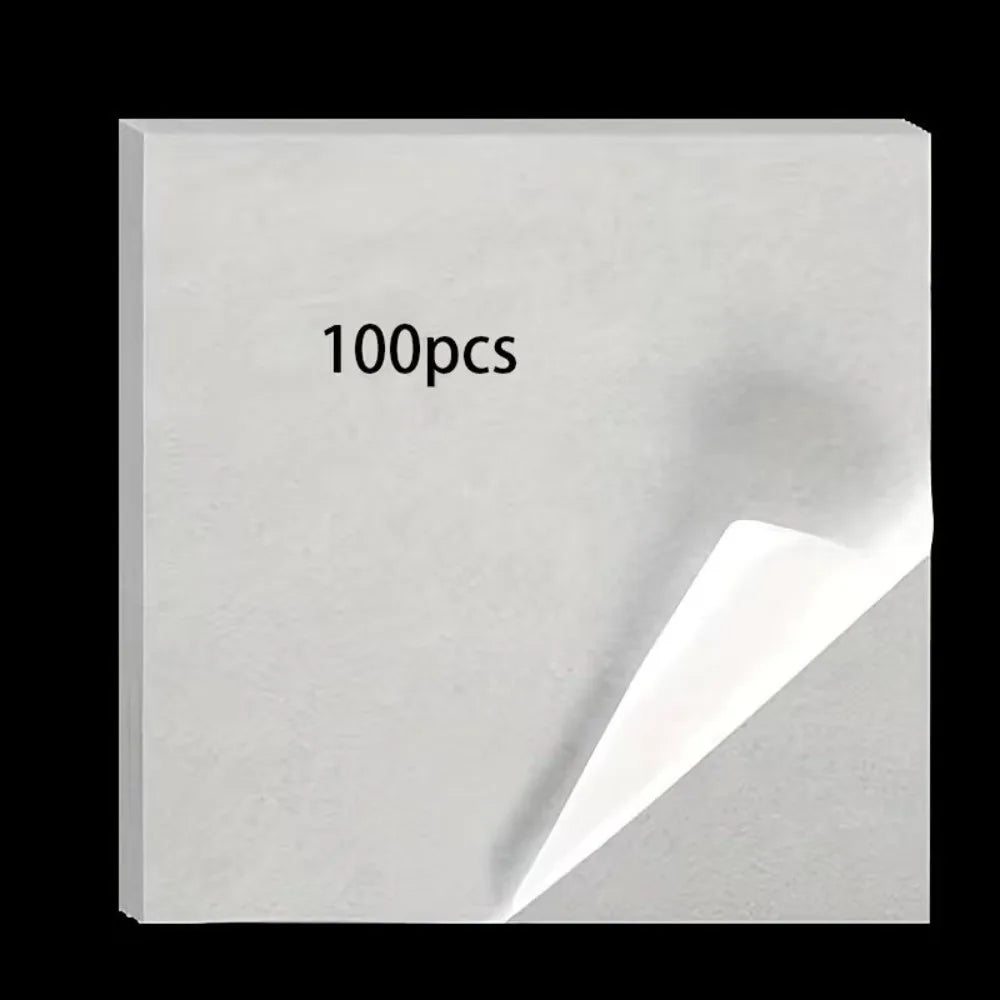 A square piece of white double-sided diamond painting release paper with the text 100pcs printed on it.