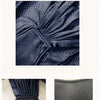 Close-up view of a dark blue fabric texture showing a quilted pattern and soft material.